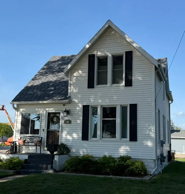 Two-story home with new charcoal gray asphalt shingle roof installation