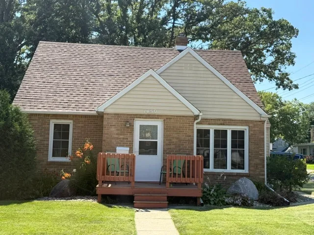 Brick ranch home with new gray dimensional asphalt shingle roof and white trim